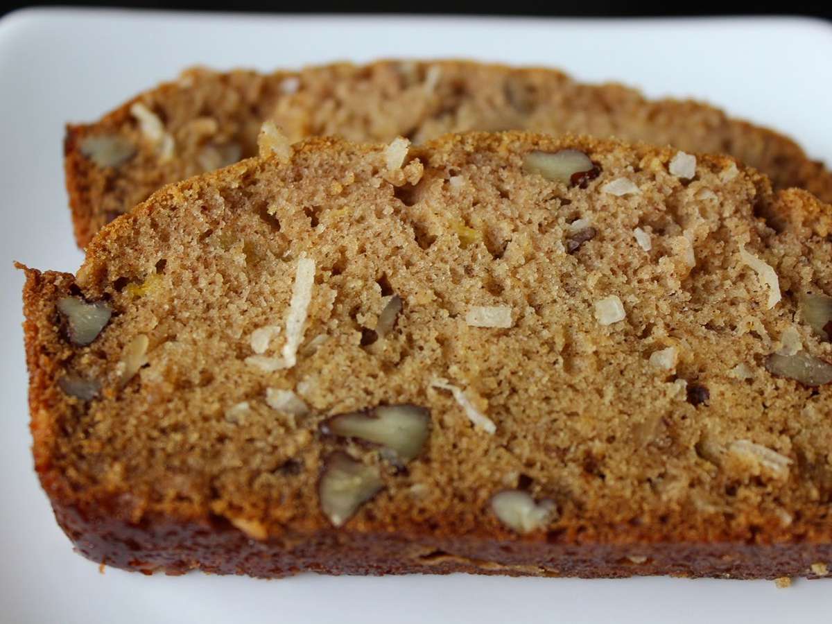 Close up view of sliced Mango Bread on a white plate