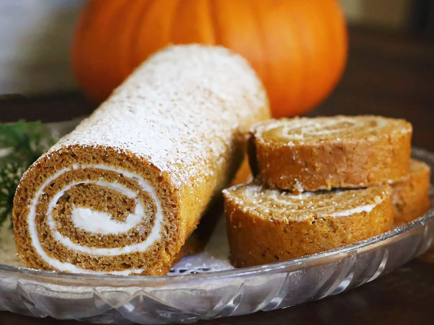 An eye level view looking into the swirl of a pumpkin roll cake. 