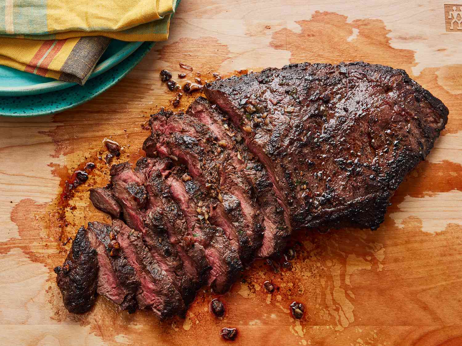 Overhead angle, looking down at sliced flat iron steak on a cutting board