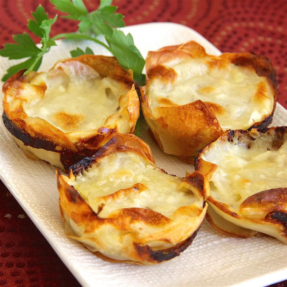 Muffin Tin Potatoes Gratin on a white dish with parsley garnish