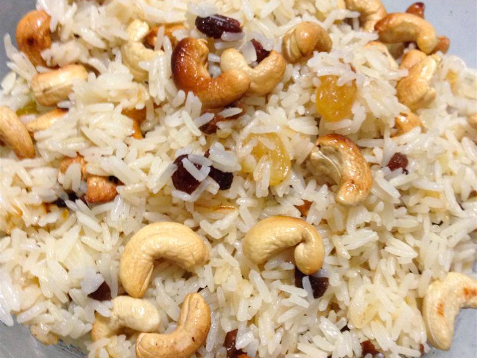 Close up view of Rice with Almonds and Raisins on a white plate