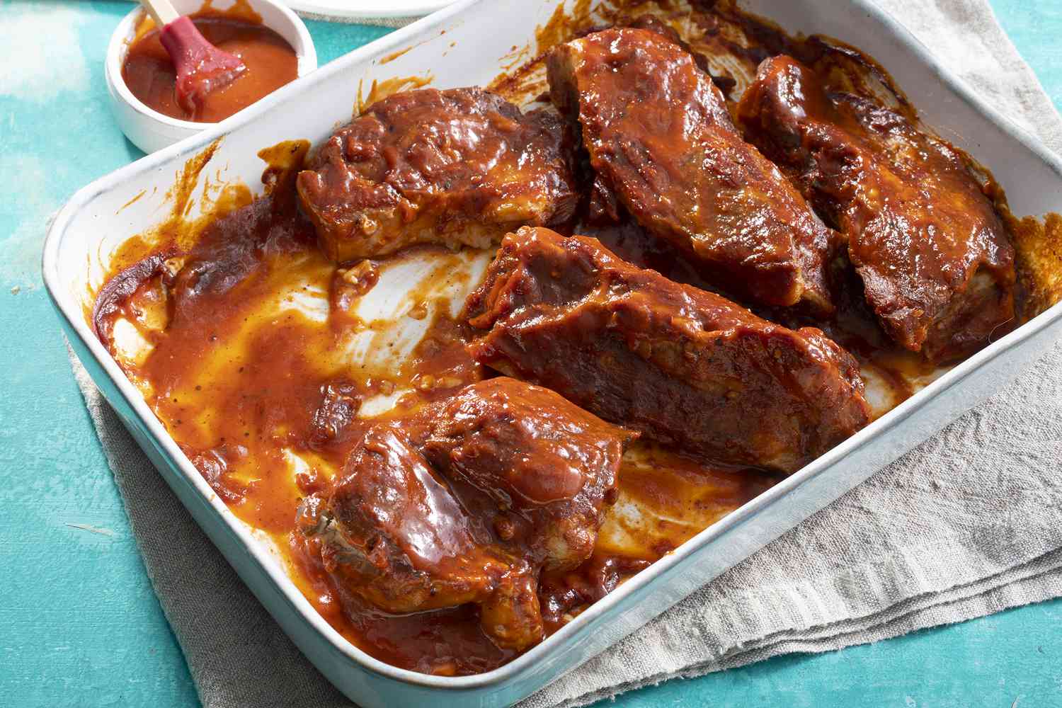 High angle view of saucy BBQ ribs served in a dish