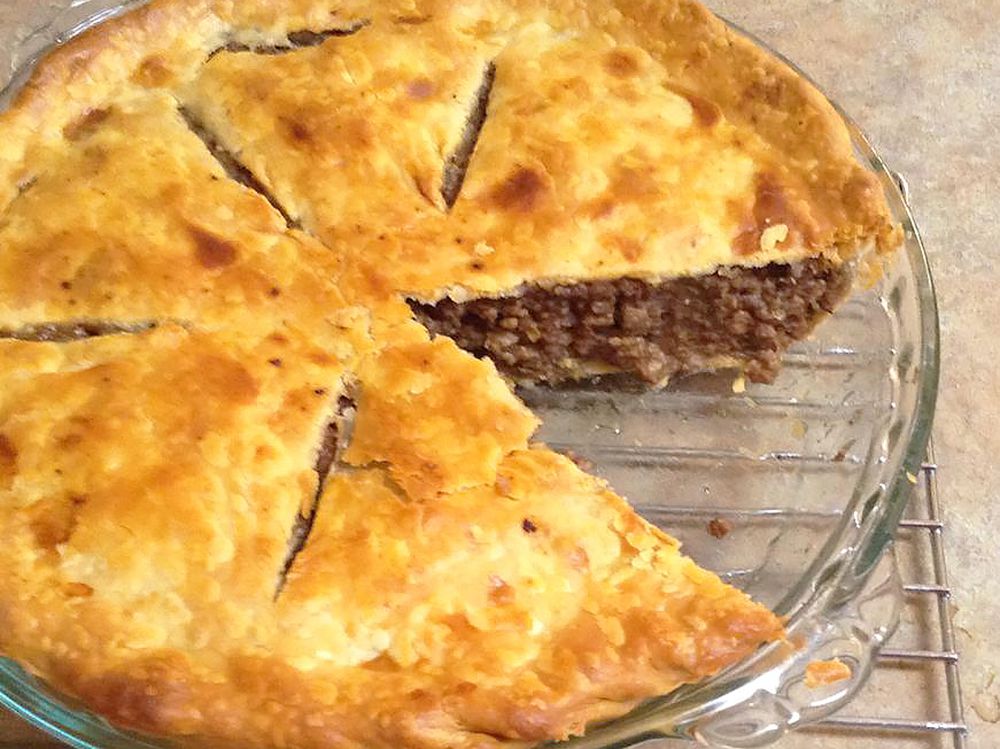 Close up view of a meat pie in a glass pie plate