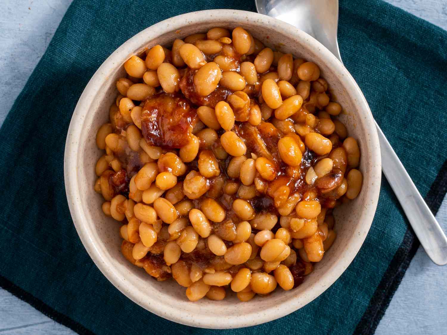 Overhead angle, looking into a bowl of Boston baked beans