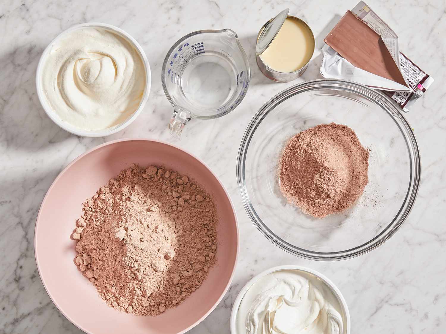 A top down view of all ingredients measured and prepped to make a chocolate trifle. 