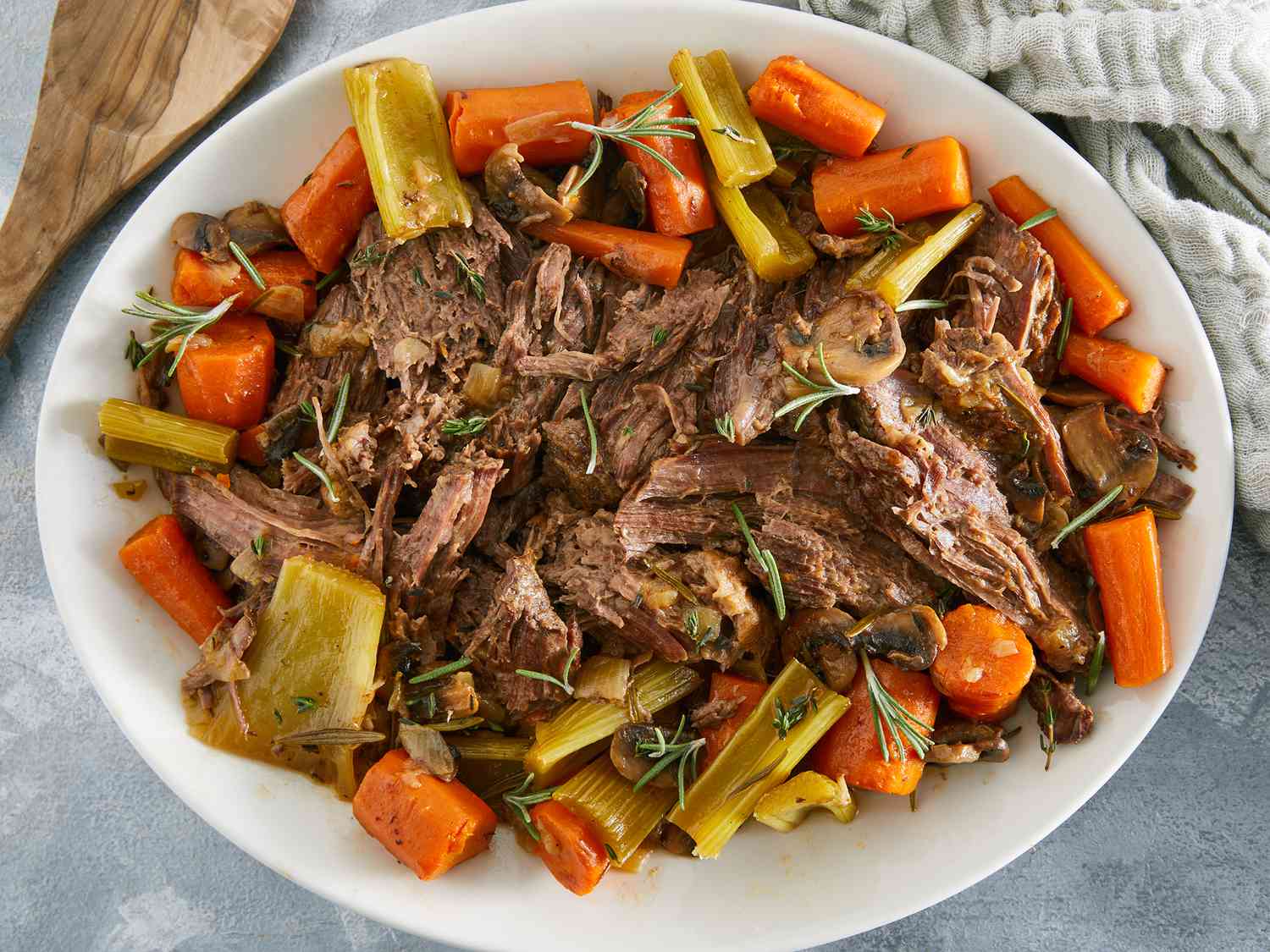 Overhead closeup of slow cooker beef pot roast on a platter with vegetables