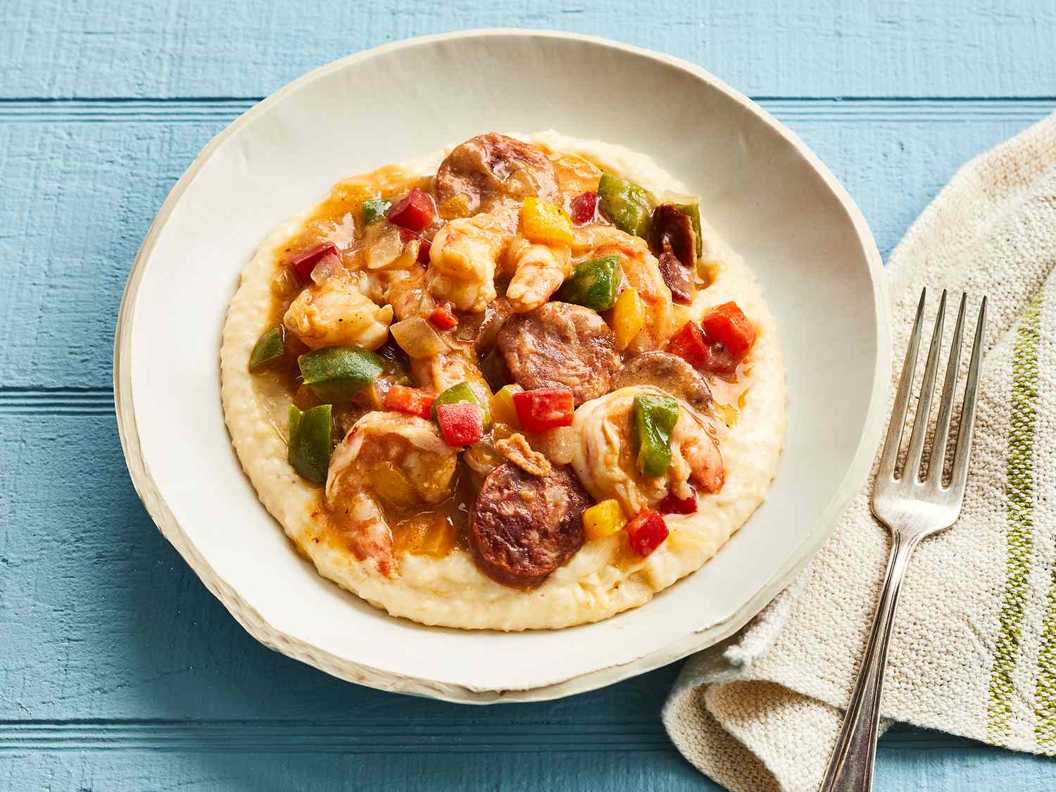 A high angle view of a single bowl of Charleston style shrimp and grits.