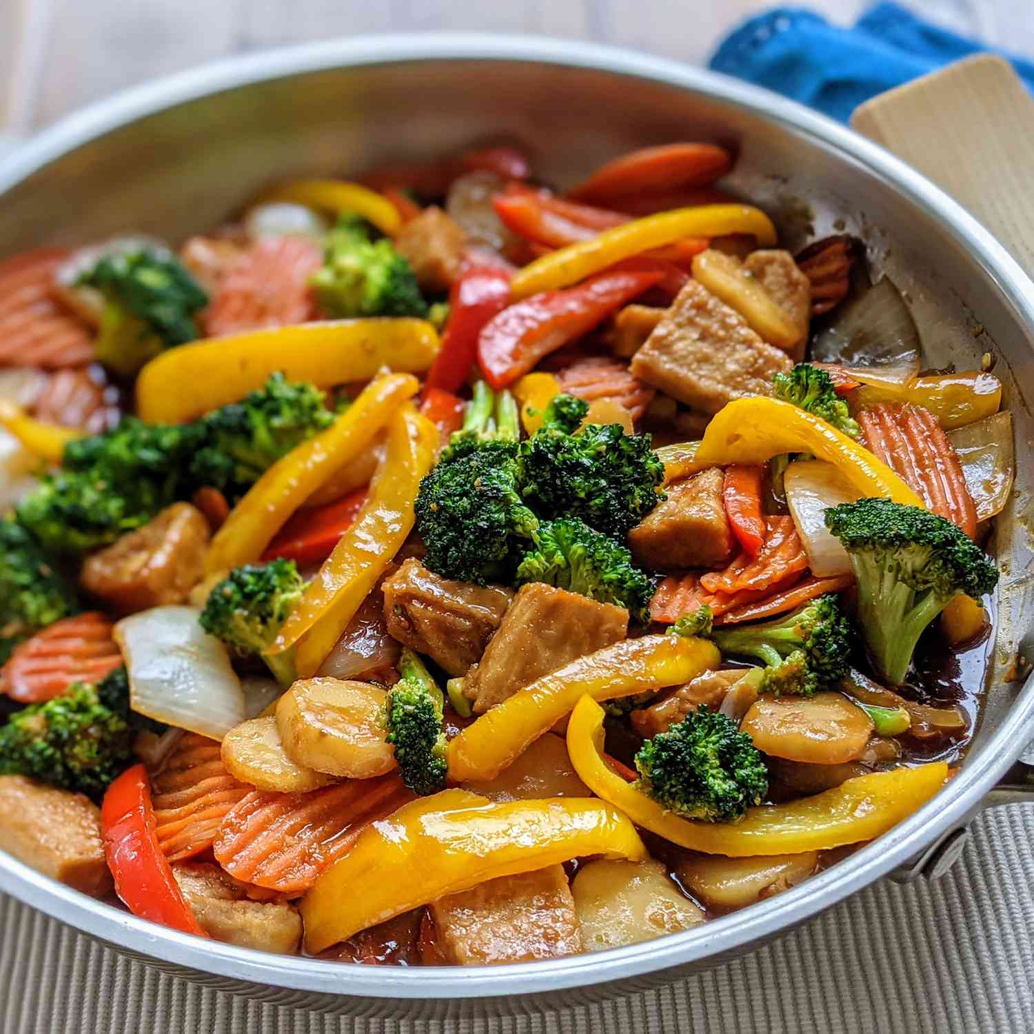 Colorful chicken stir fry in a stainless steel skillet