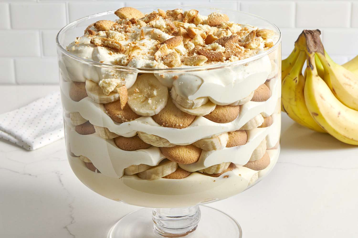 A low angle view looking into the side of a trifle dish layered with the best banana pudding