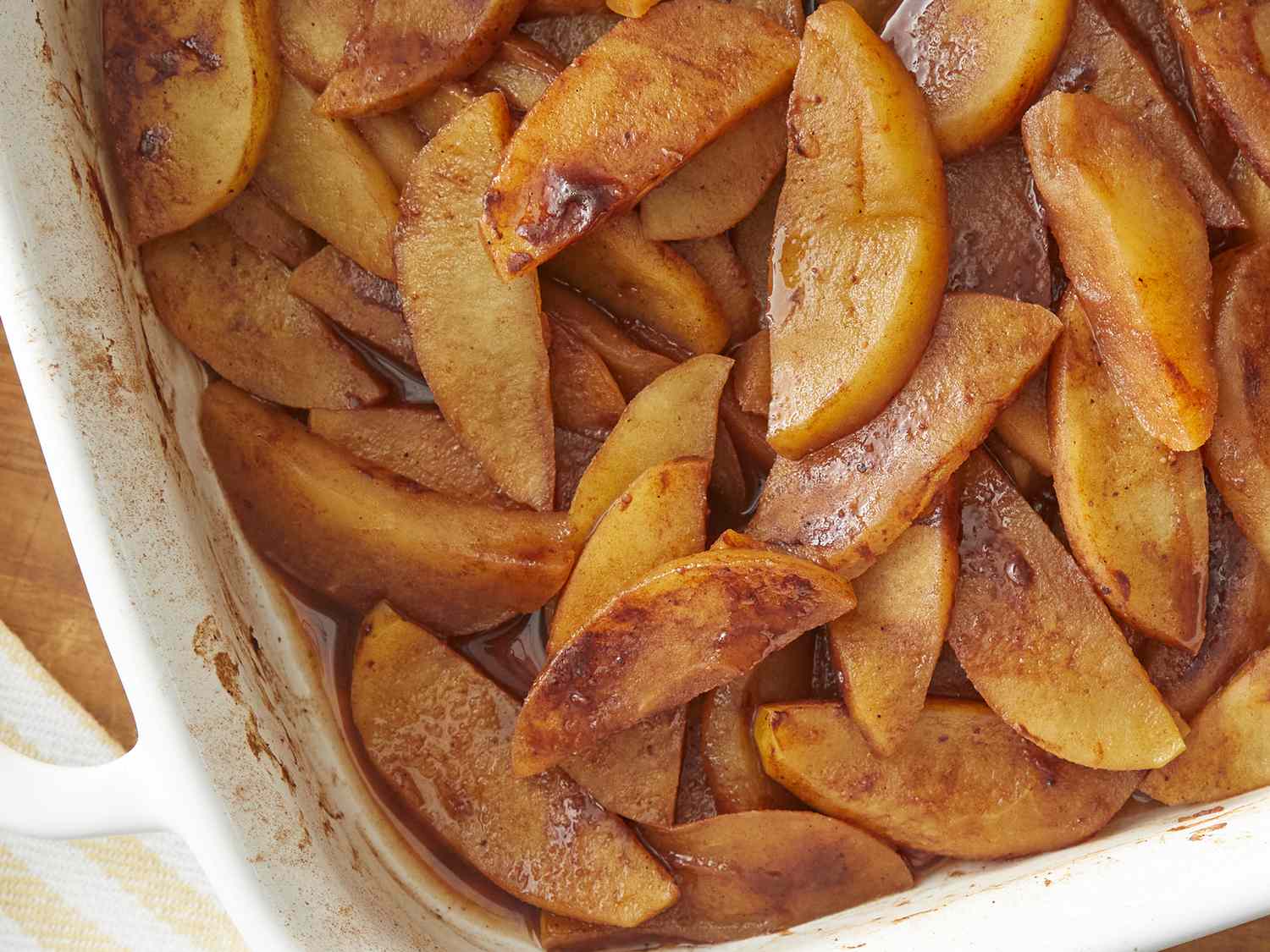 Looking down at a casserole dish of sliced cinnamon baked apples