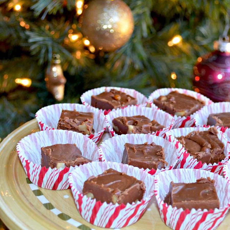 Plate of individually wrapped fudge in front of a Christmas tree