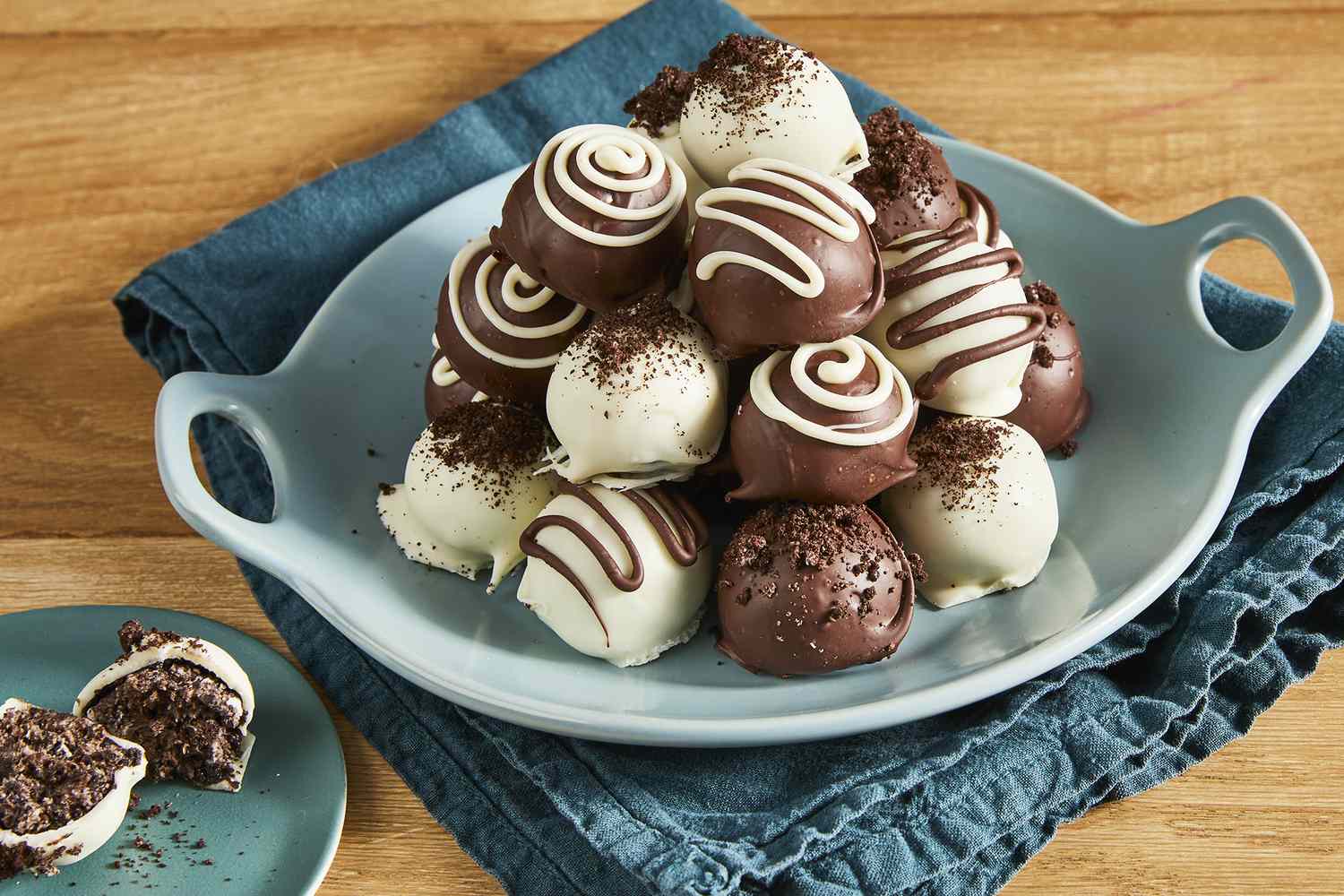 A pile of milk chocolate and white chocolate covered Oreo cookie balls