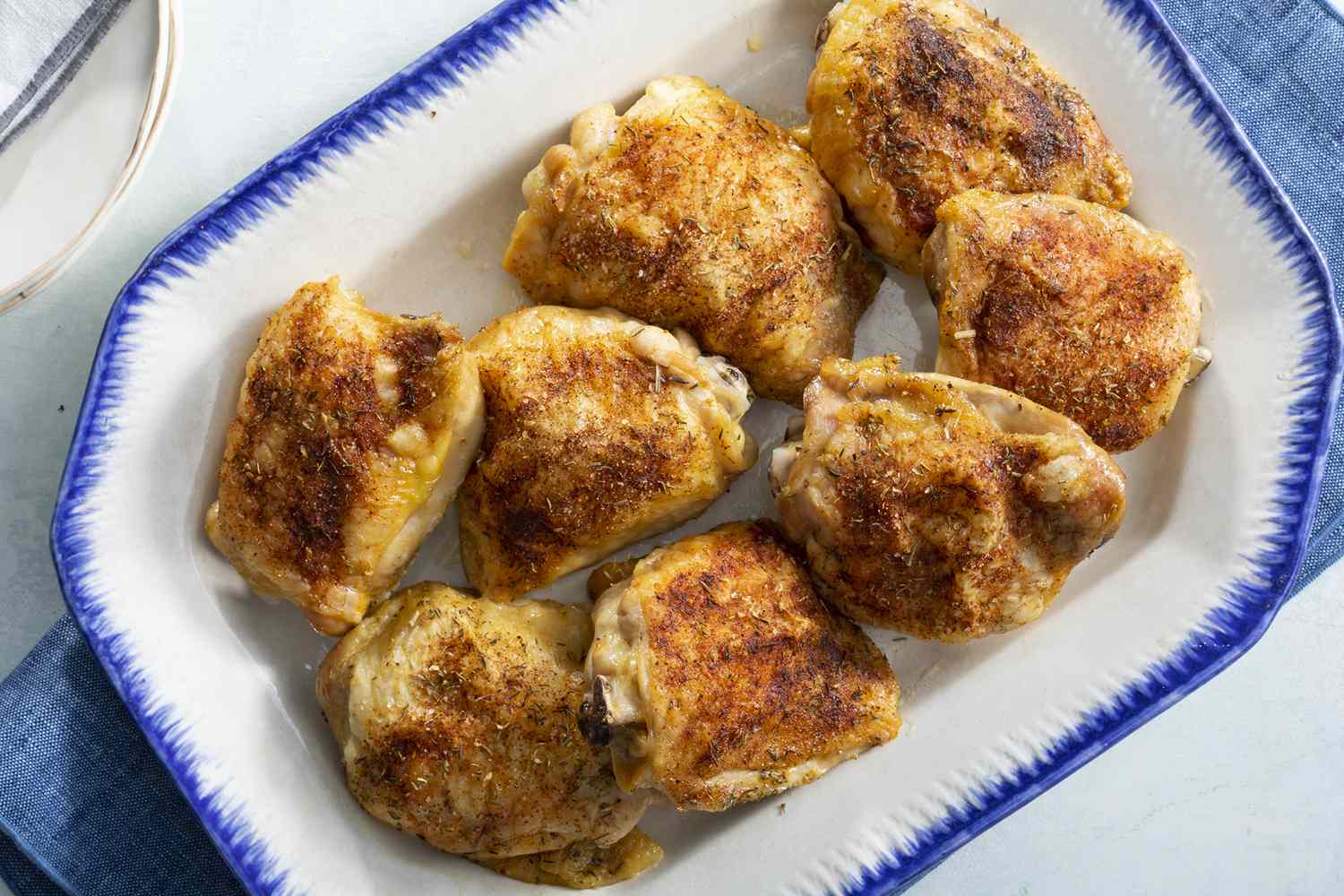 Overhead view of crispy and tender chicken thighs served on a dish