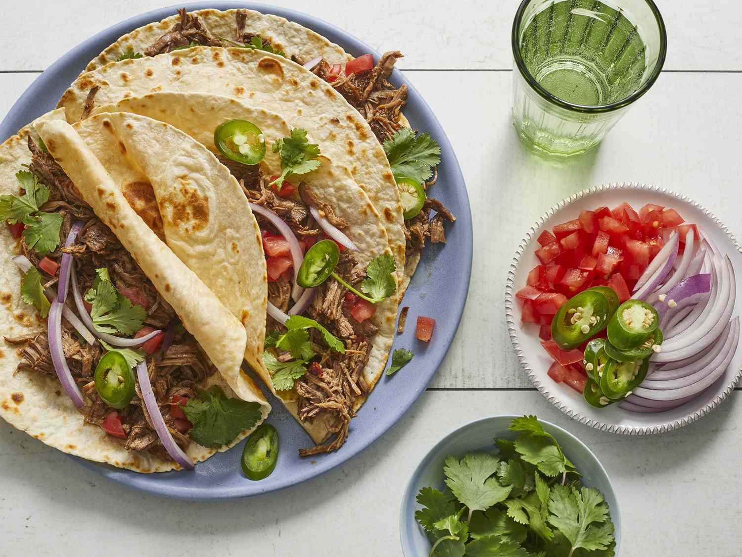 Looking down at a few barbacoa-style shredded beef tacos