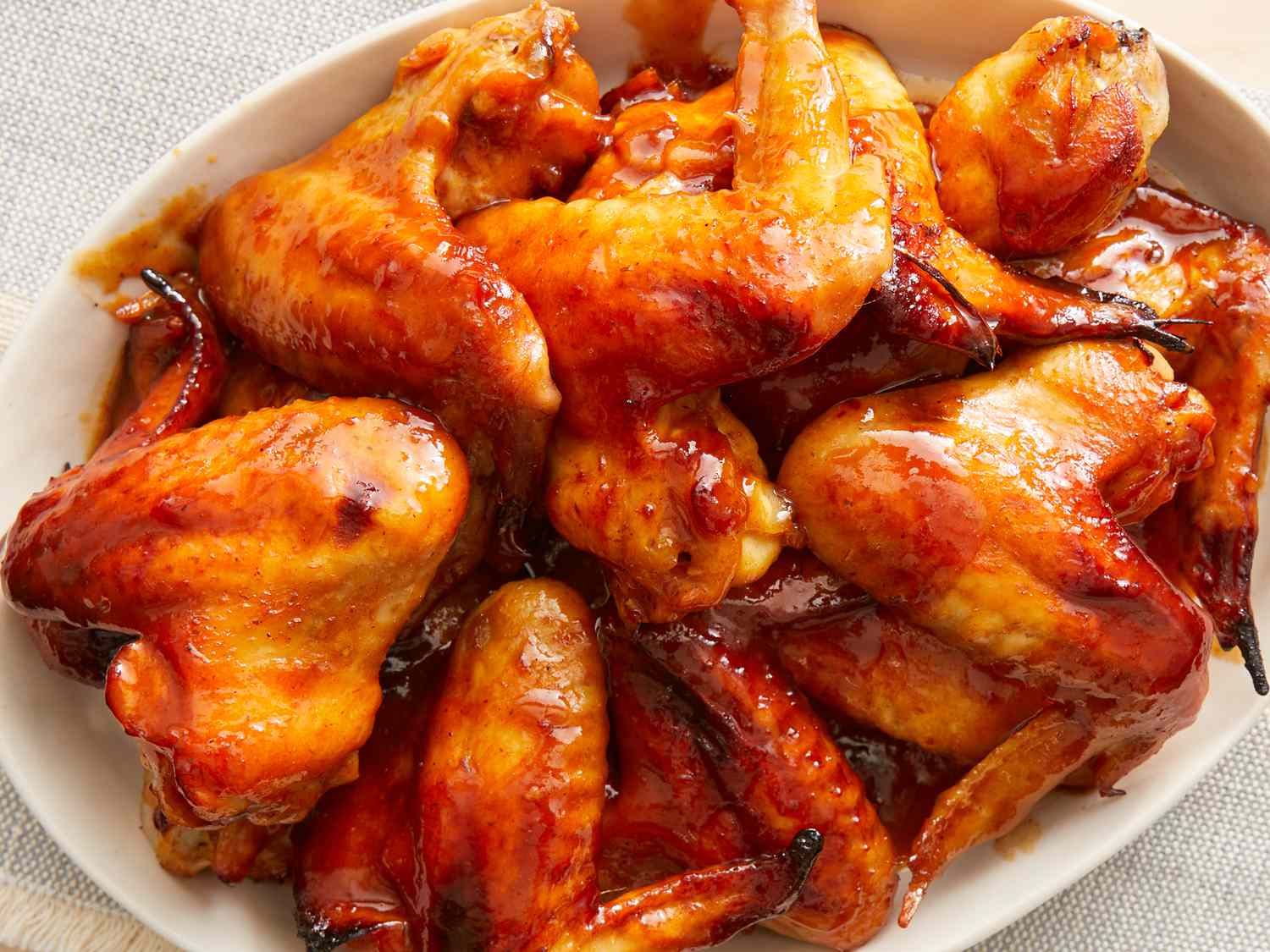 Overhead looking down at a shallow bowl full of bbq chicken wings