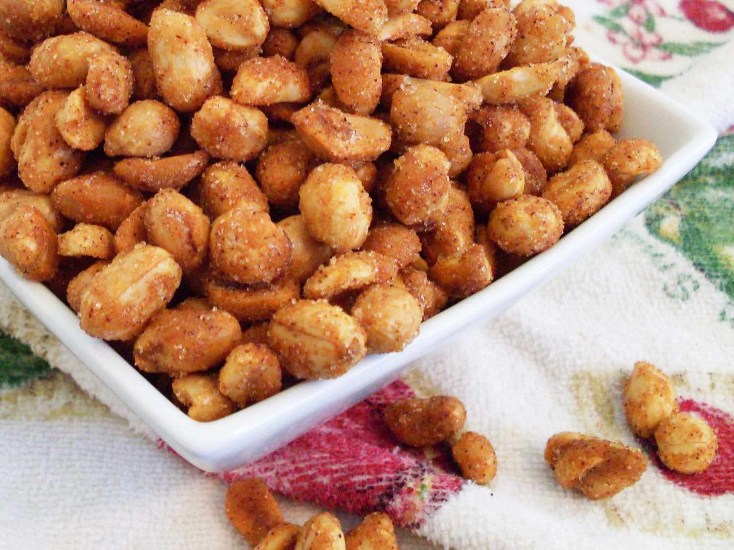 Close up view of Chipotle Honey Roasted Peanuts in a white bowl