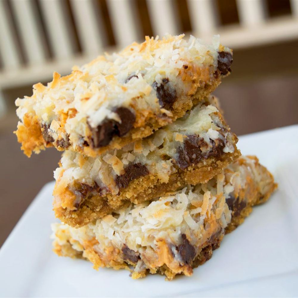 Close up view of a stack of Seven Layer Bars on a plate