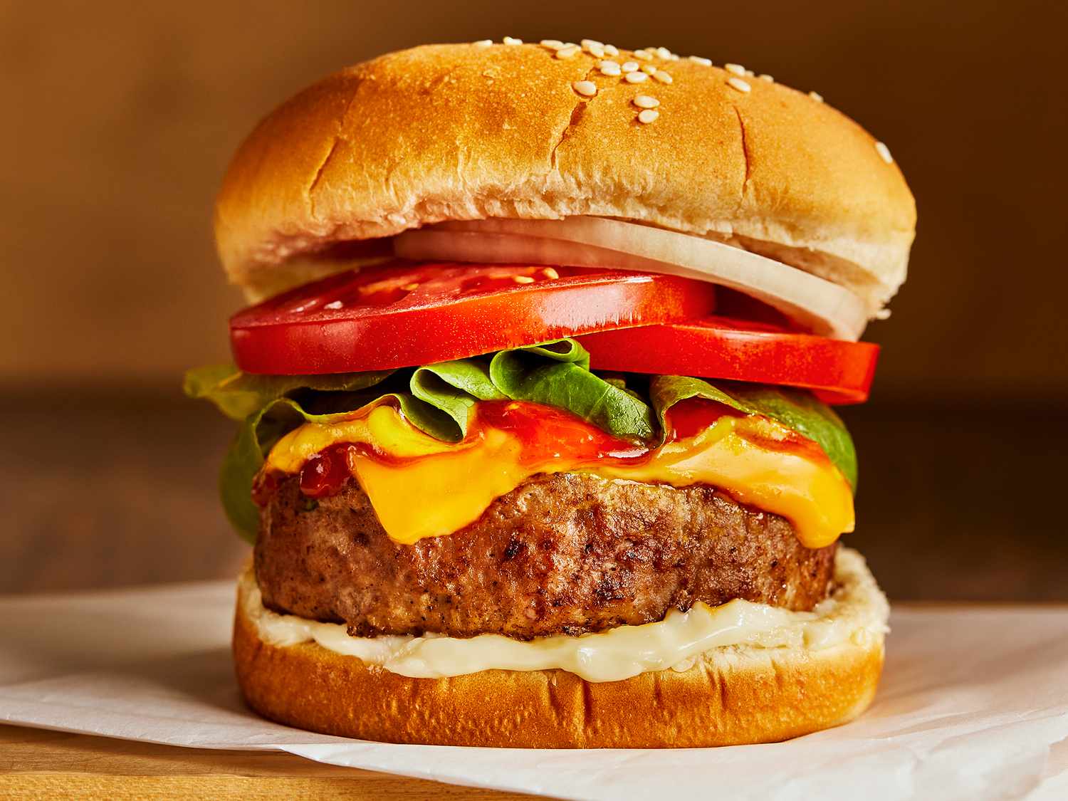 A juicy turkey burger topped with cheese, lettuce, tomato, onion, ketchup, mustard, and mayo.