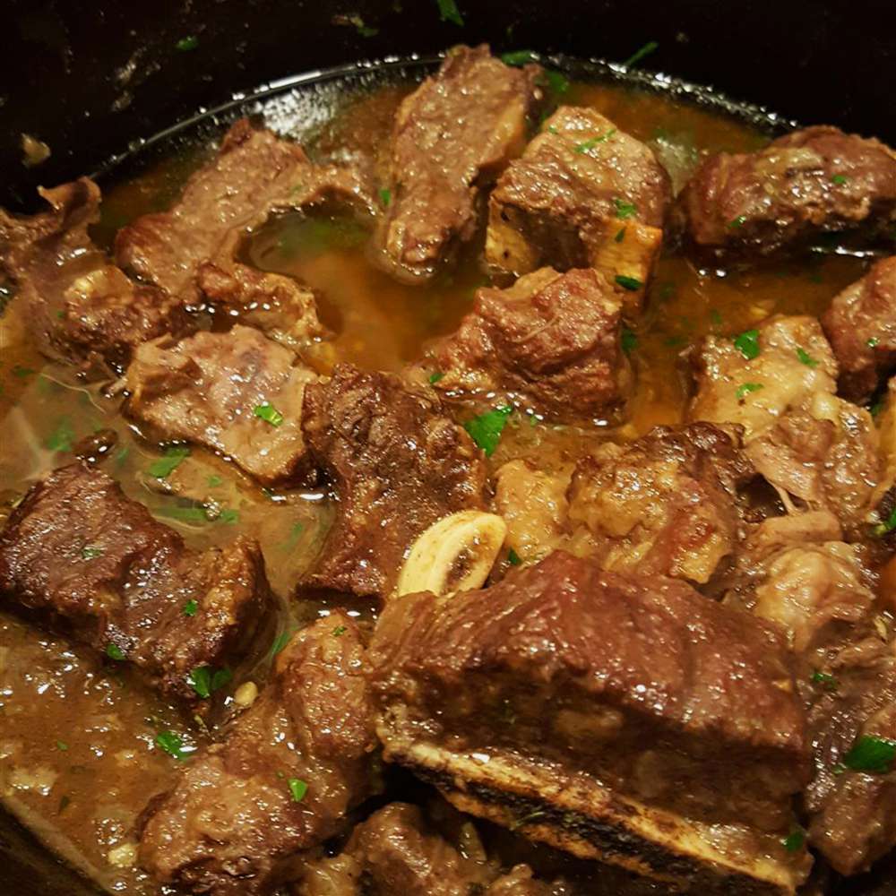 Close up view of Simple Beef Short Ribs with herbs in a pot