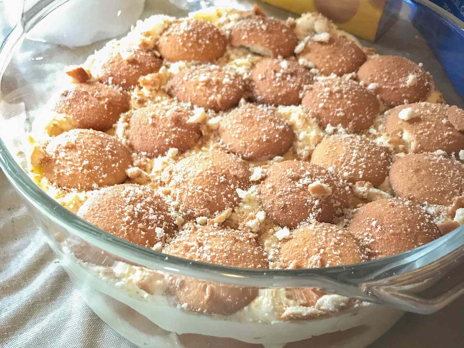 Close up view of Banana Pudding topped with vanilla wafers in a glass bowl