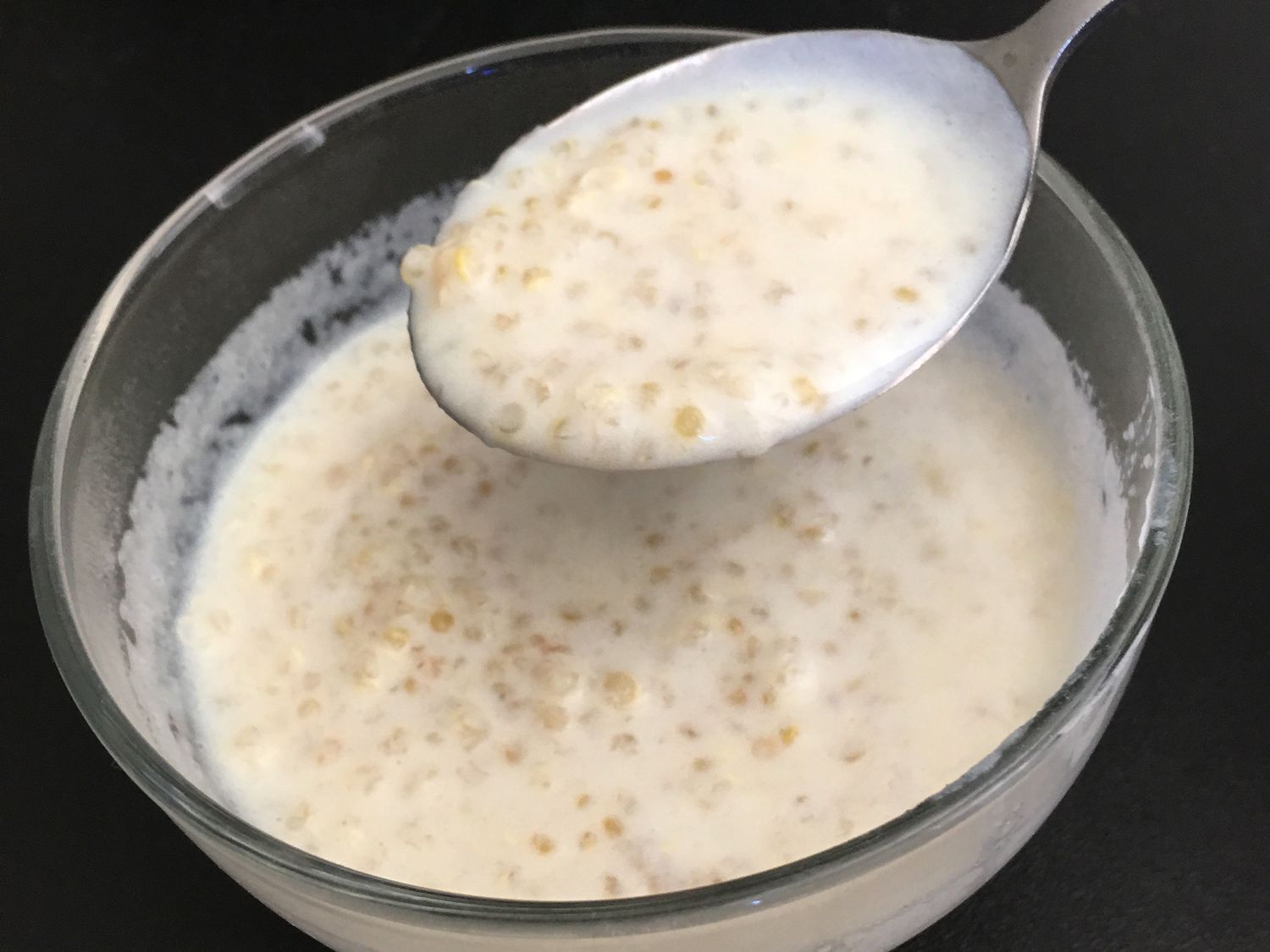 Close up view of Quinoa Pudding in a bowl with a spoon