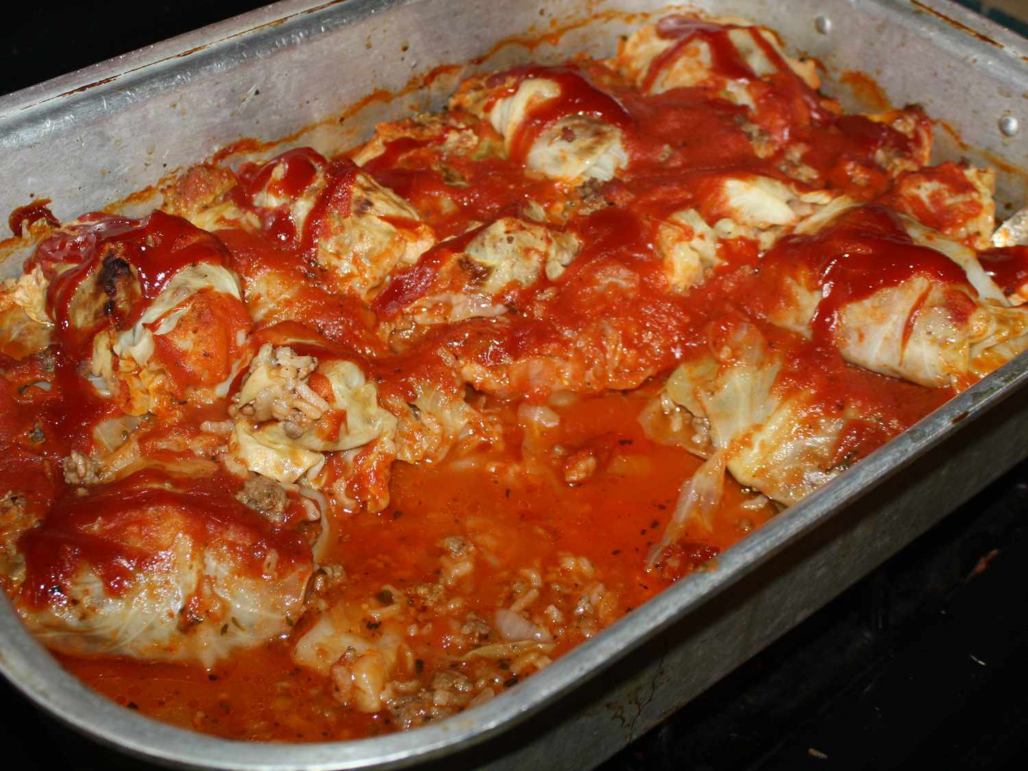 Close up view of Golabki (Stuffed Cabbage Rolls) in a baking dish on a stove