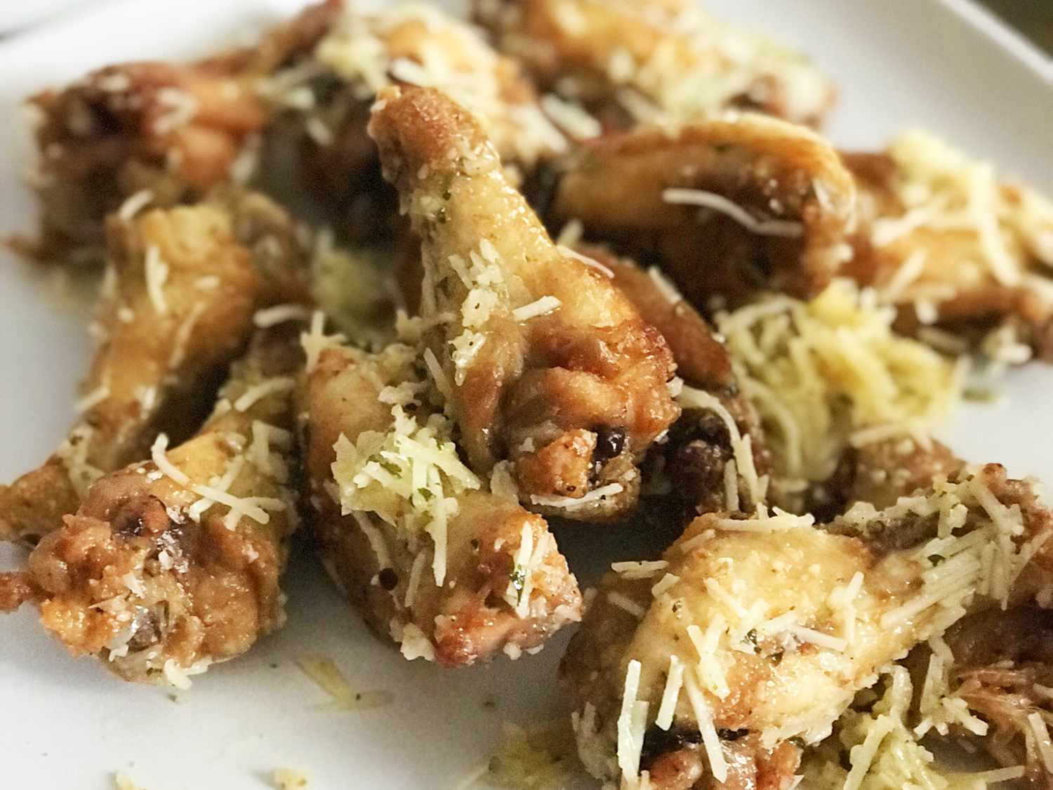 Close up view of chicken wings coated in Garlic-Parmesan Wing Sauce
