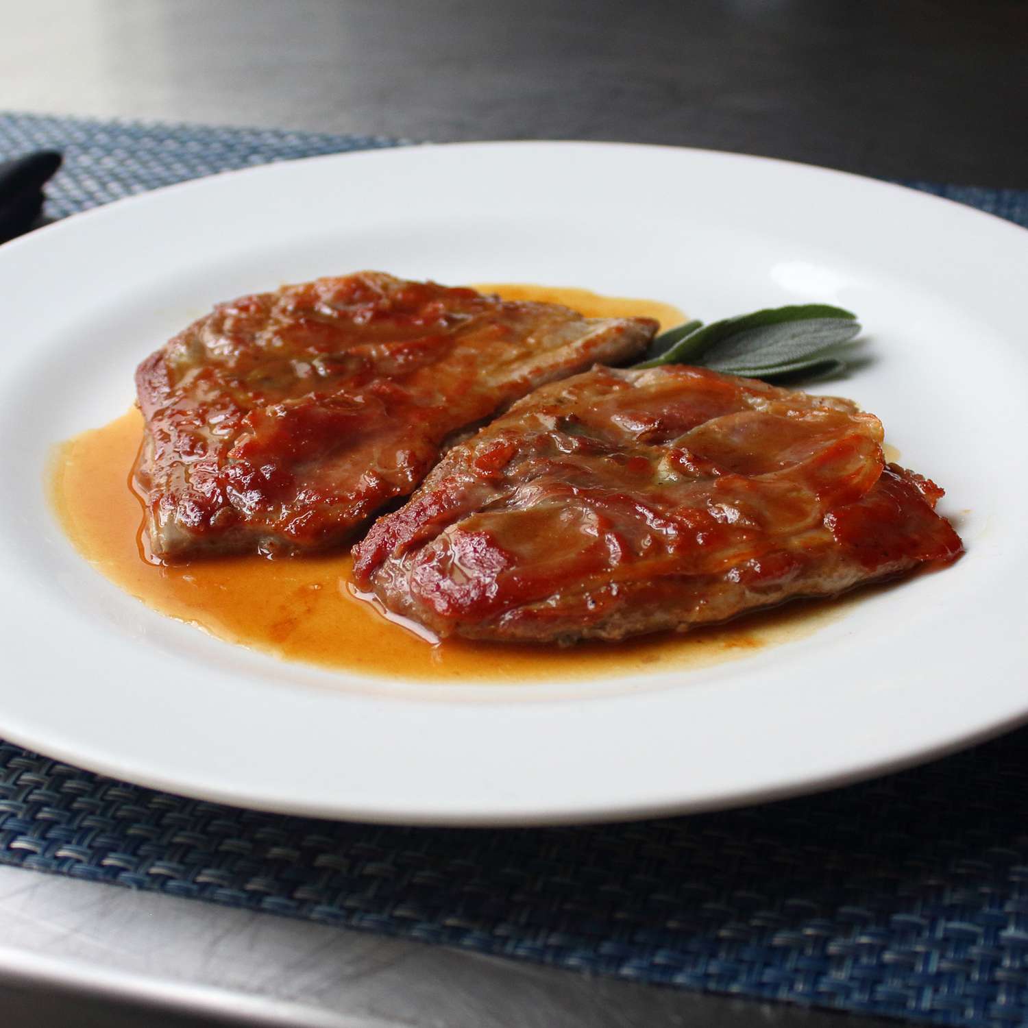 Close up view of Pork Saltimbocca on a white plate