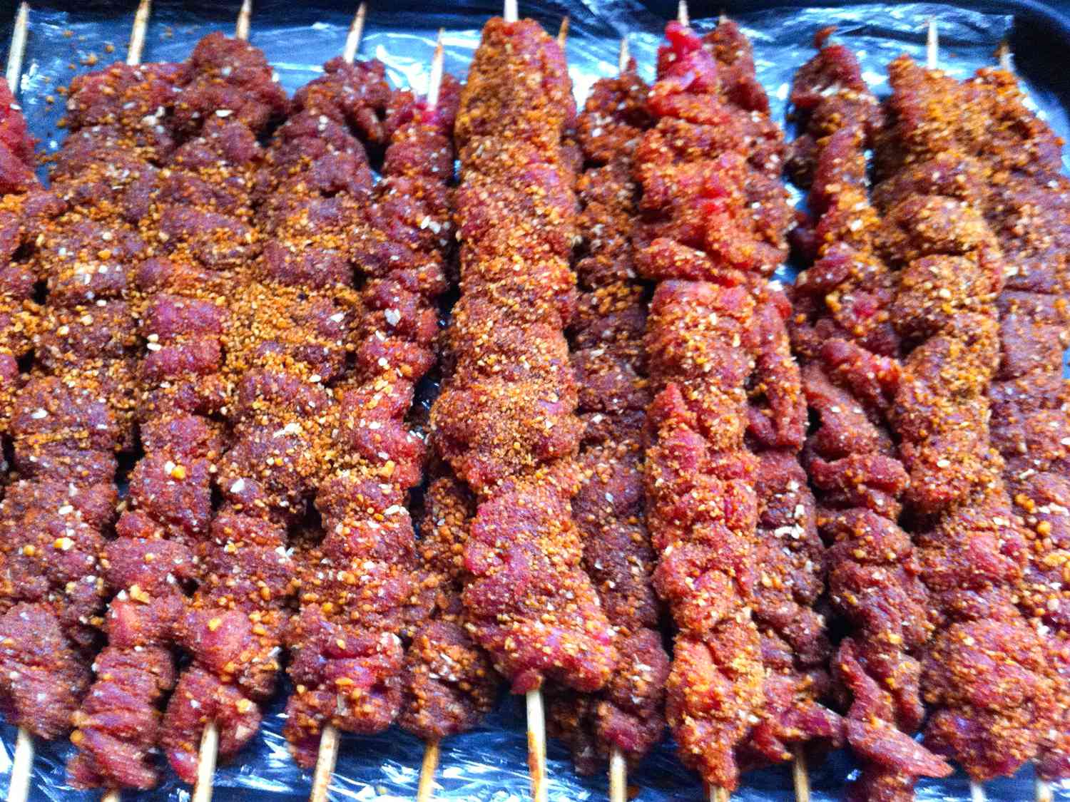 Close up view of seasoned meat on skewers for Nigerian Suya