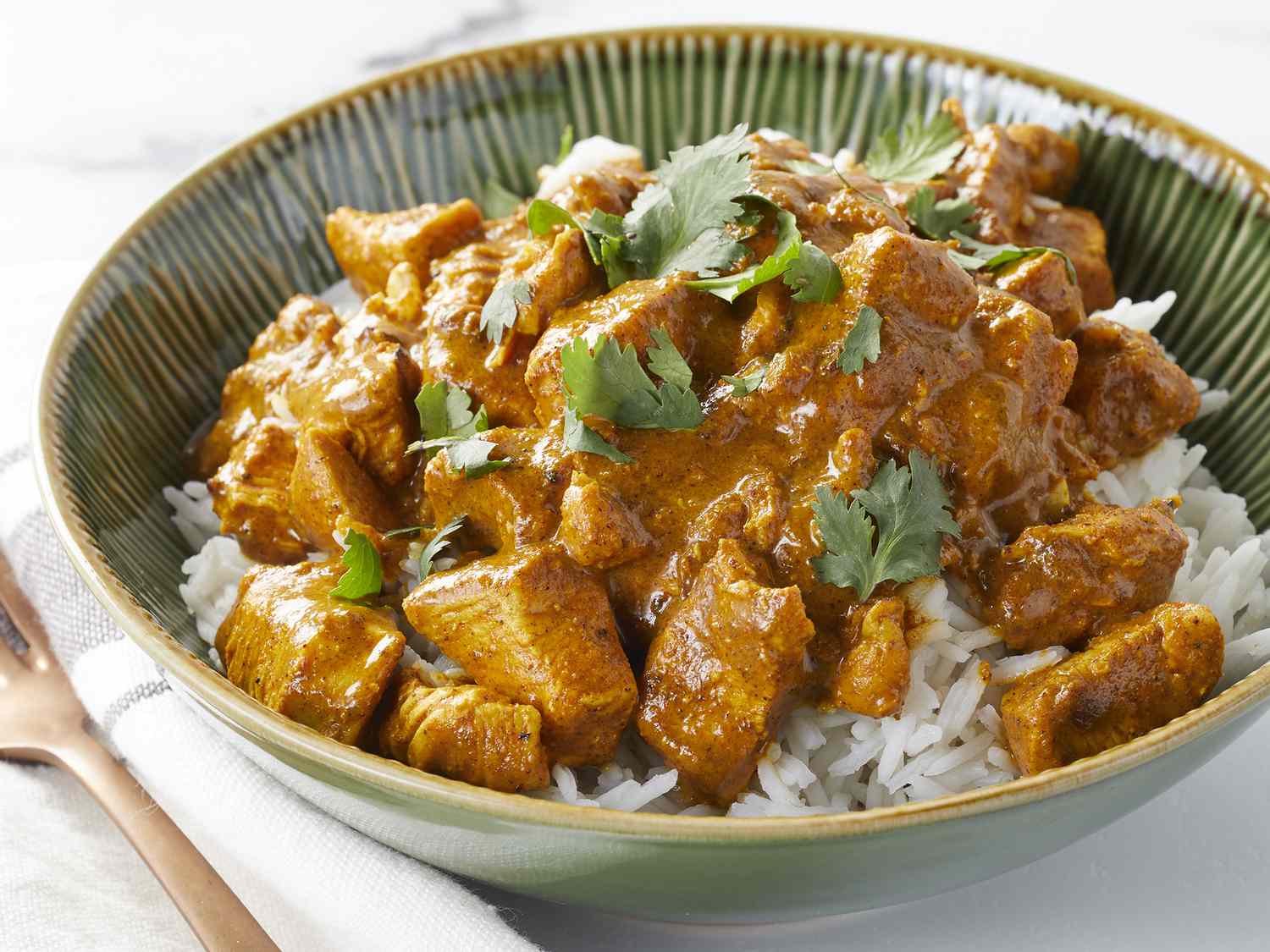 High angle looking at a bowl of Indian Chicken Curry served on top of rice