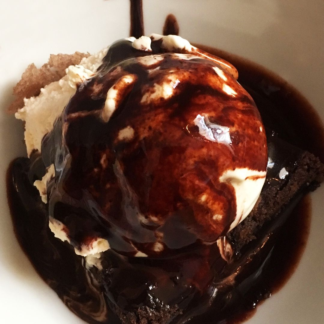 Close up view of ice cream covered with Chocolate Syrup in a bowl