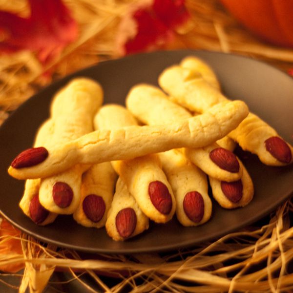 Close up view of Spooky Witches' Fingers cookies on a black plate