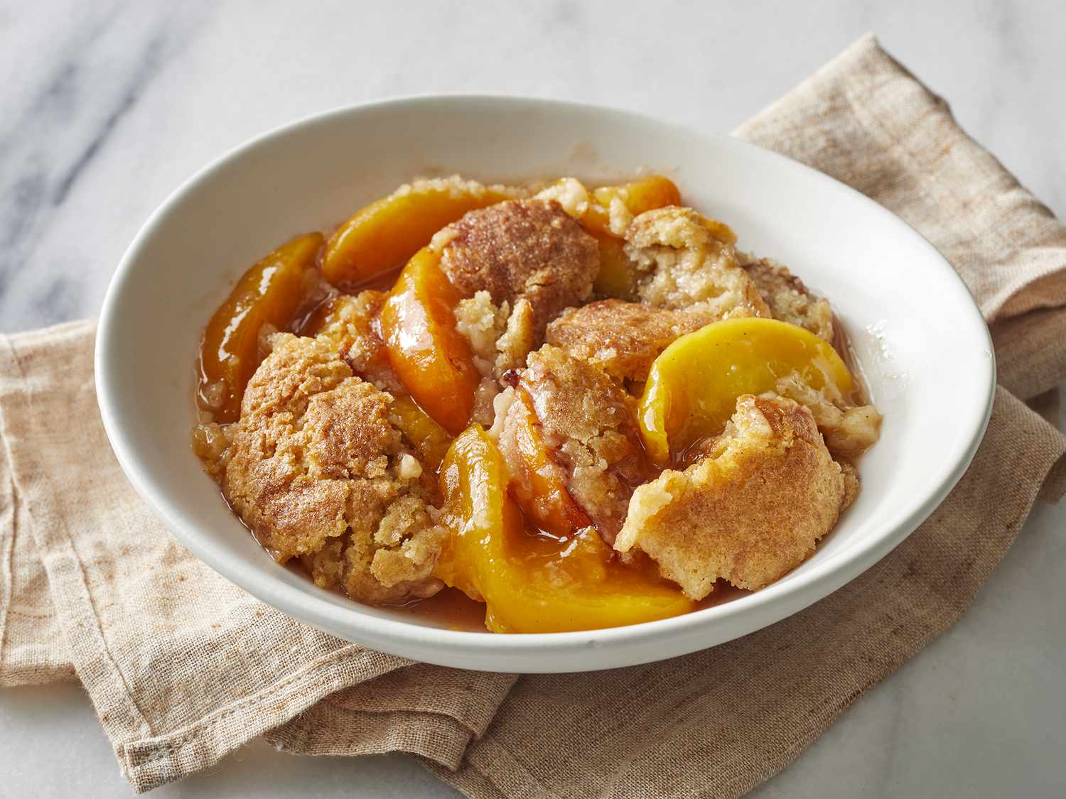 High angle looking at a bowl full of peach cobbler