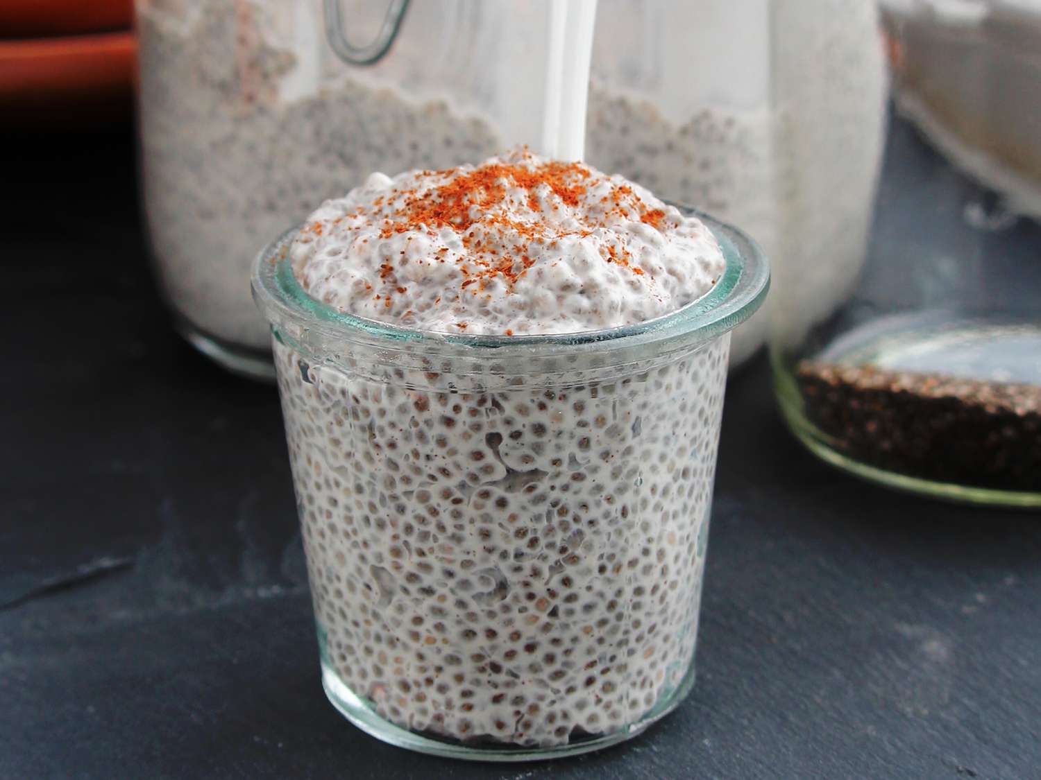 Close up view of a glass with chia coconut pudding garnished with cinnamon