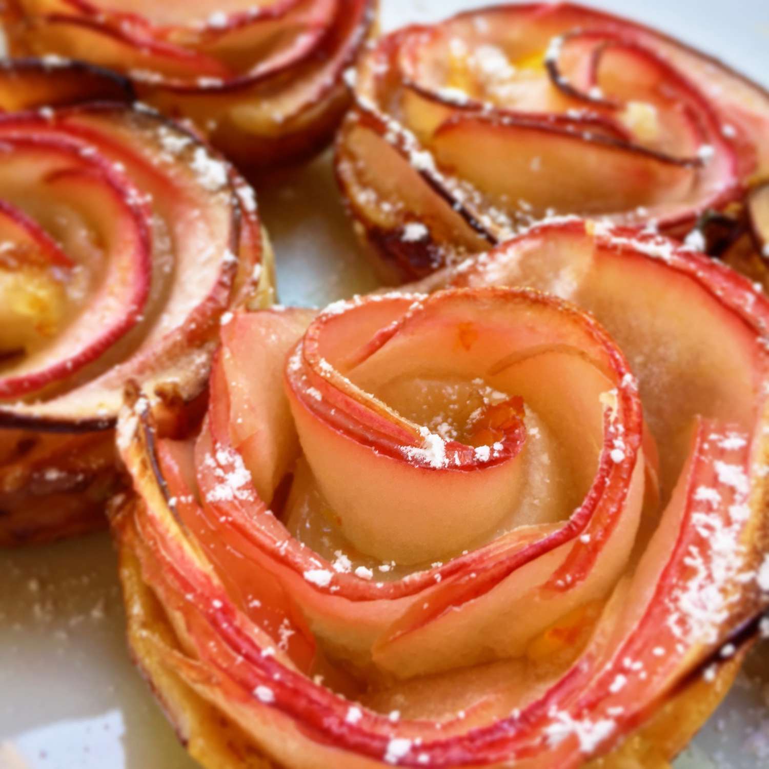 Close up view of Baked Apple Roses garnished with powdered sugar