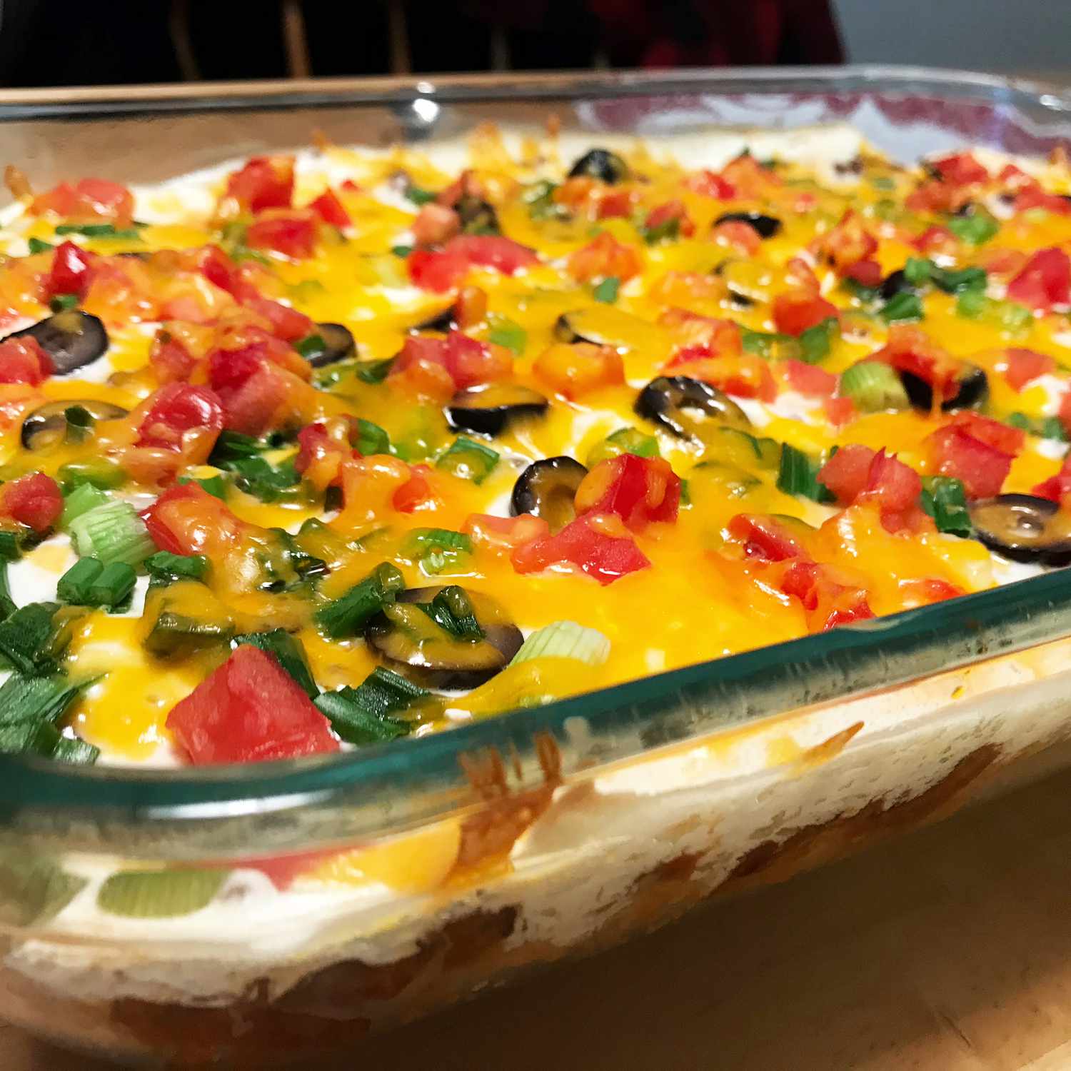 Close up view of a Mexican casserole in a glass baking dish