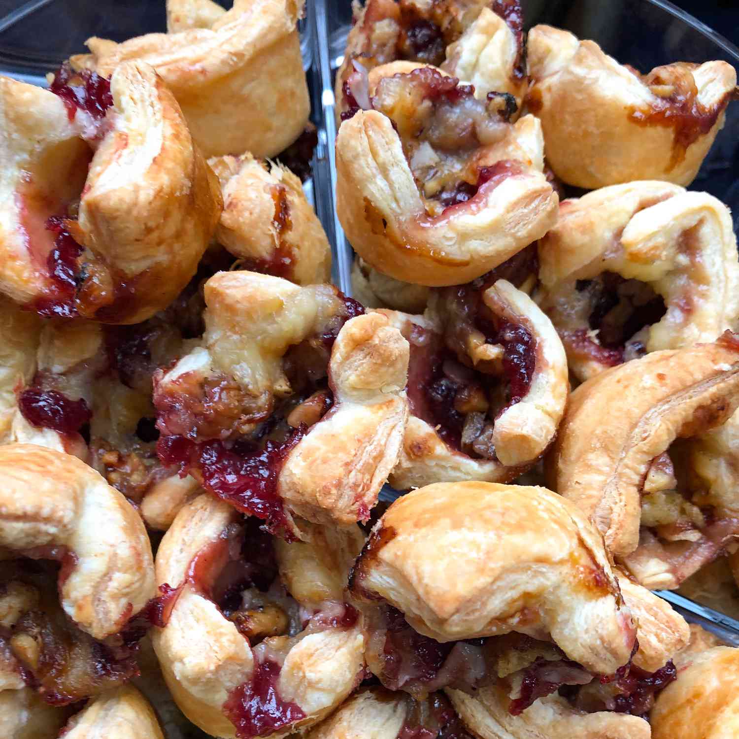 Close up view of a pile of Cranberry Brie Bites in a bowl