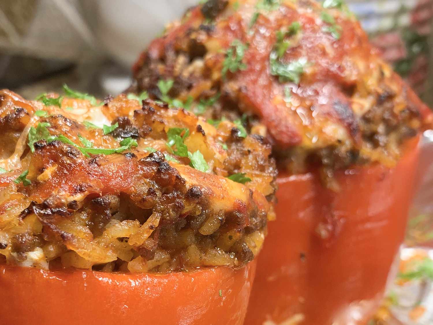Close up view of Stuffed Red Peppers garnished with fresh herbs