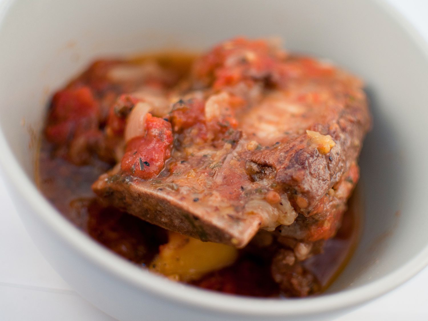 Close up view of Short Ribs in a white bowl