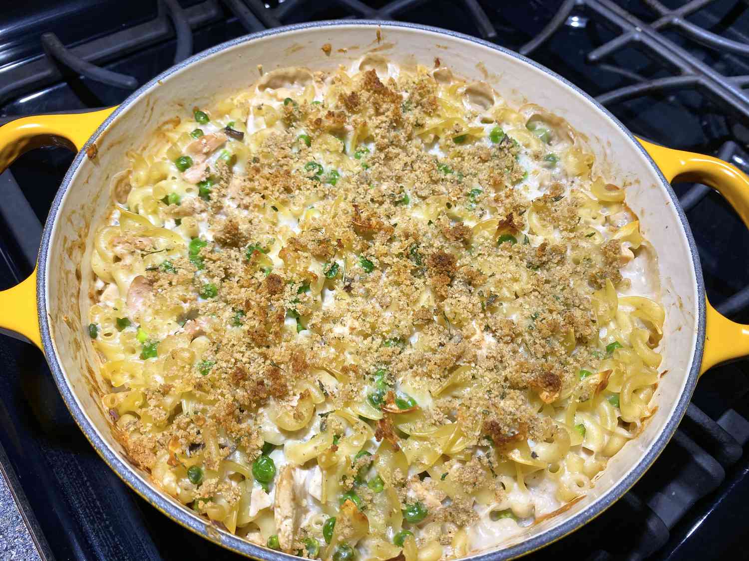Close up view of Campbell's Tuna Noodle Casserole with peas in a yellow pan on the stove