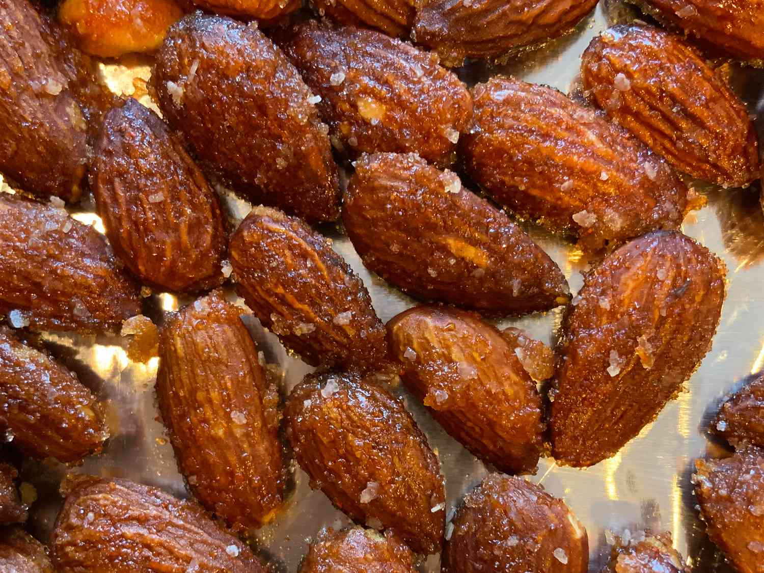 Close up view of Sweet and Spicy Almonds on a metal surface