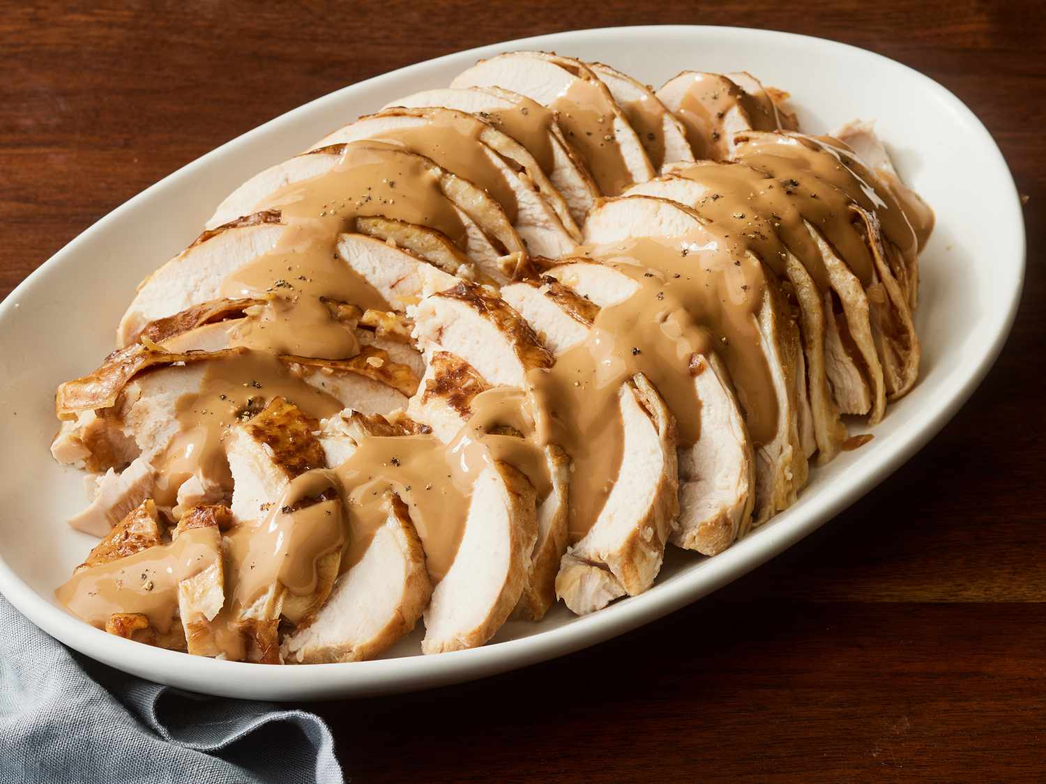 Close up on a platter of sliced, slow cooker turkey breast.