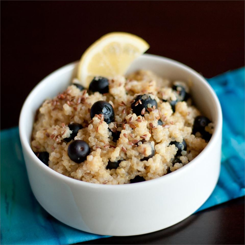 Blueberry Lemon Breakfast Quinoa with a lemon garnish in a white bowl